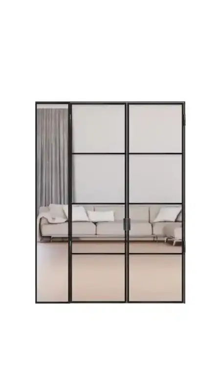 Modern loft door with black metal frame and glass panel consisting of two glass doors with fixed side panels and a bright living area in the background